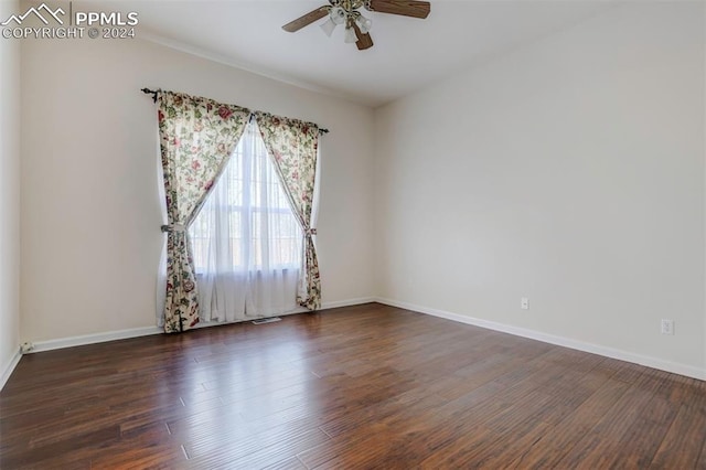 empty room featuring ceiling fan and dark wood-type flooring