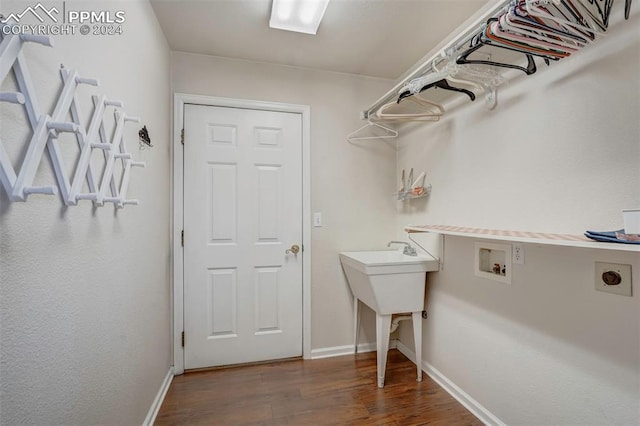 laundry room featuring hookup for an electric dryer, hookup for a washing machine, and dark hardwood / wood-style flooring