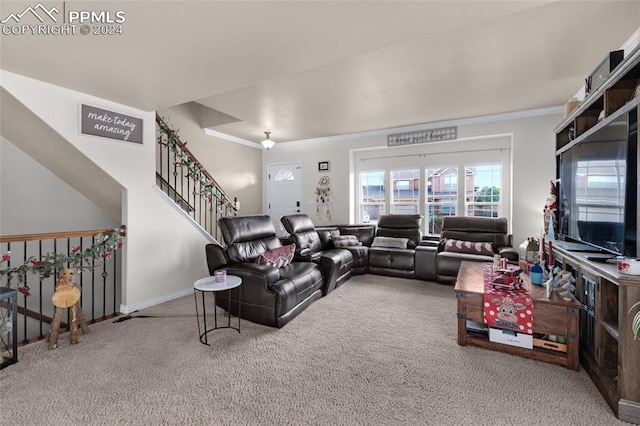 carpeted living room with crown molding