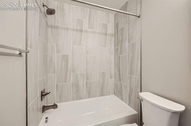 bathroom with toilet and tiled shower / bath