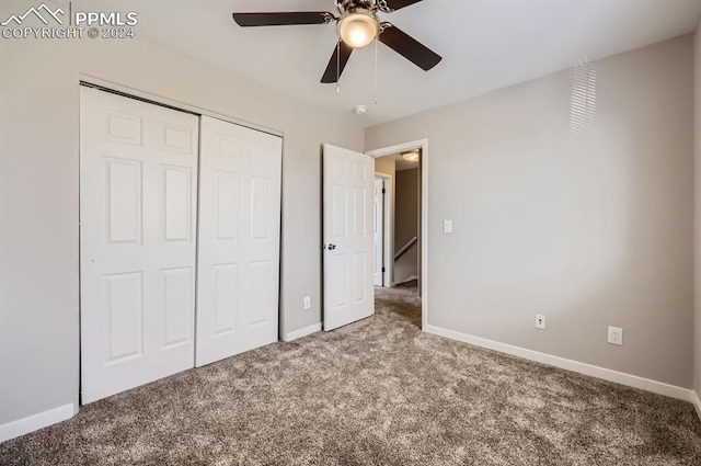 unfurnished bedroom featuring carpet floors, a closet, and ceiling fan