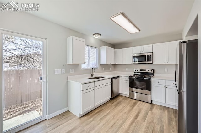 kitchen featuring sink, white cabinets, and appliances with stainless steel finishes