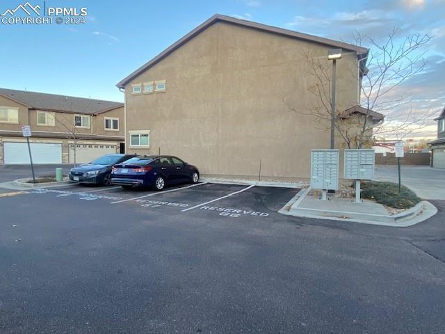 view of parking featuring mail boxes