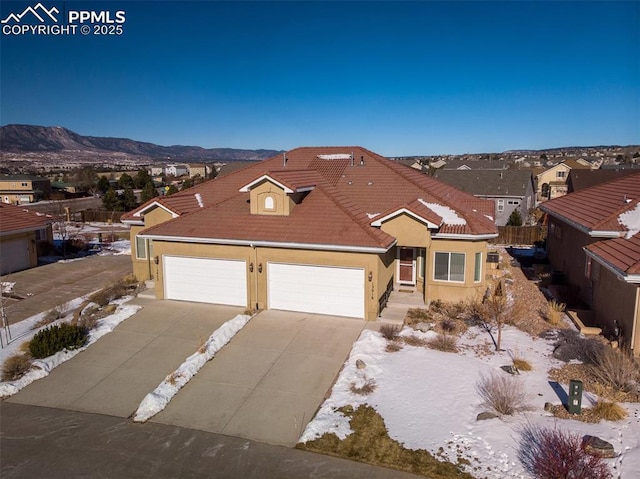 view of front of property with a garage and a mountain view