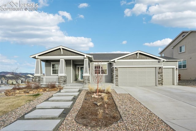 craftsman inspired home with a porch and a garage