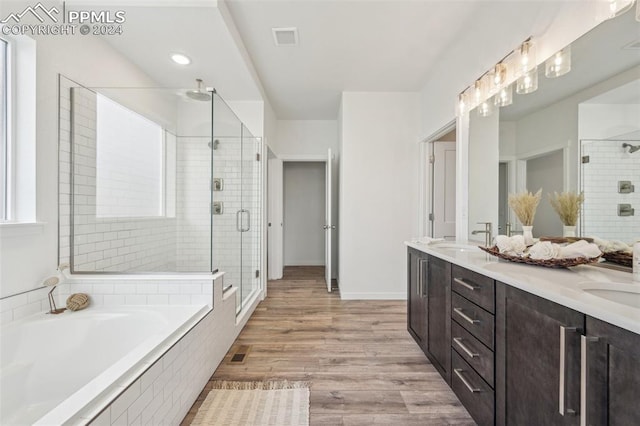 bathroom featuring hardwood / wood-style flooring, vanity, and independent shower and bath