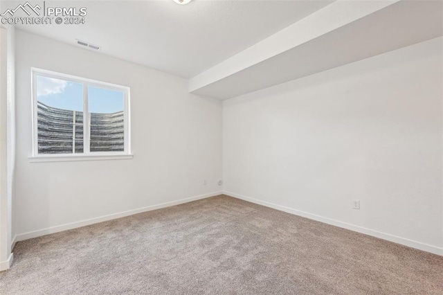 empty room with light colored carpet