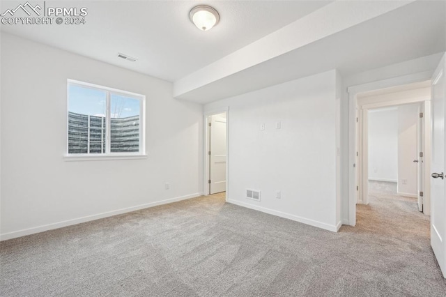 empty room featuring light colored carpet