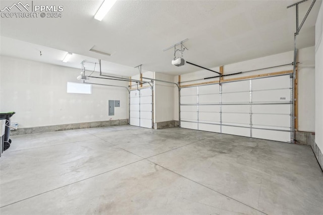 garage featuring electric panel and a garage door opener