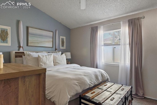 carpeted bedroom featuring a textured ceiling, ceiling fan, and lofted ceiling