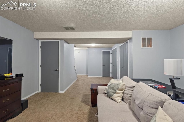 bedroom featuring light colored carpet and a textured ceiling