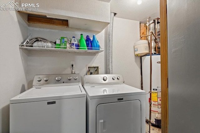 laundry room with independent washer and dryer and water heater