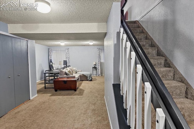 interior space with a textured ceiling and carpet floors