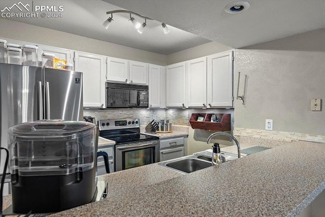 kitchen with white cabinetry, sink, appliances with stainless steel finishes, and tasteful backsplash