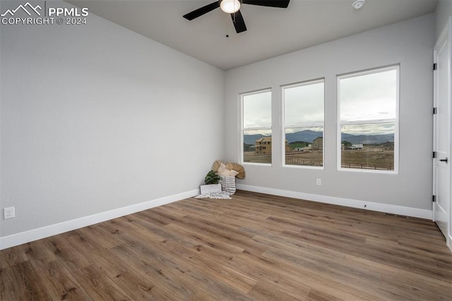 empty room featuring hardwood / wood-style flooring and ceiling fan