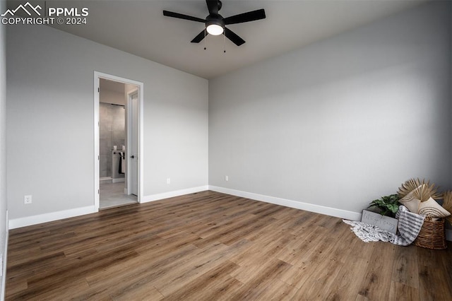 spare room with ceiling fan and wood-type flooring