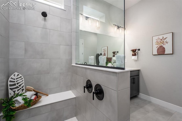 bathroom with tile patterned floors, vanity, and a shower