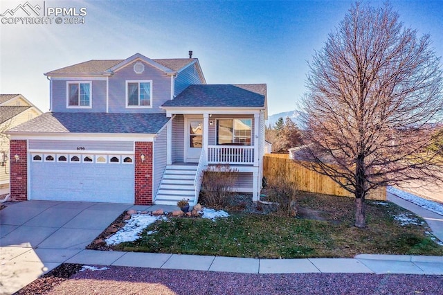 view of front of house featuring covered porch and a garage