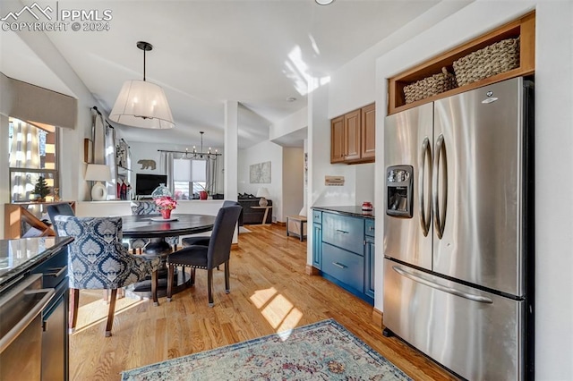 kitchen featuring stainless steel fridge with ice dispenser, light hardwood / wood-style flooring, and pendant lighting