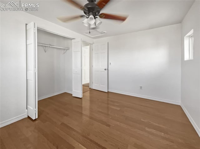 unfurnished bedroom featuring dark hardwood / wood-style flooring, a closet, and ceiling fan