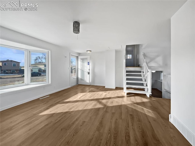 unfurnished living room with wood-type flooring