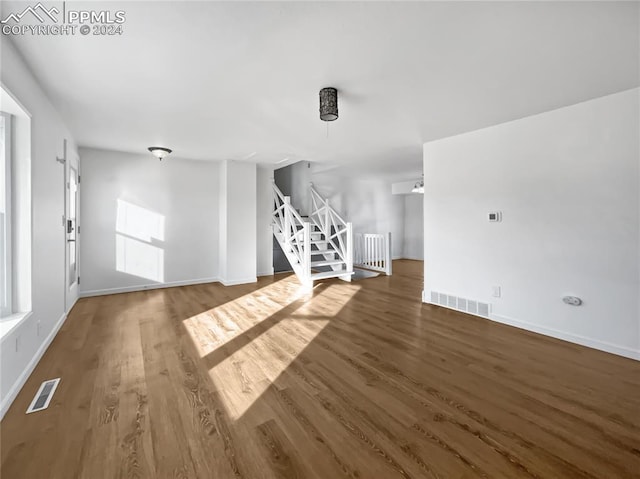 additional living space featuring dark hardwood / wood-style floors