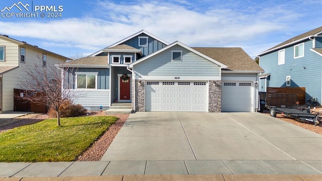 view of front of home featuring a garage and a front lawn