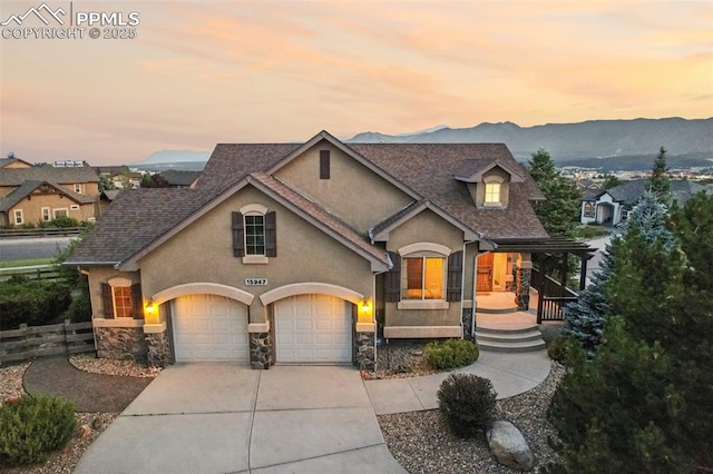 view of front of house with a garage and a mountain view