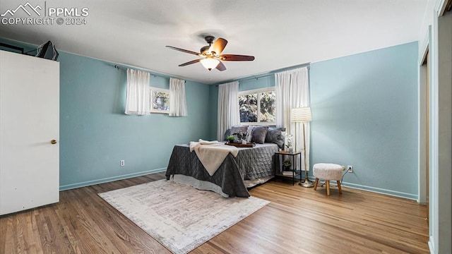 bedroom with hardwood / wood-style flooring and ceiling fan