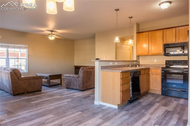 kitchen featuring kitchen peninsula, dark hardwood / wood-style flooring, and black appliances