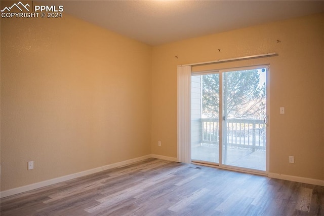 unfurnished room featuring hardwood / wood-style floors