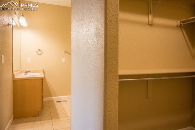 bathroom featuring tile patterned flooring and vanity