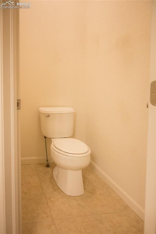 bathroom with tile patterned floors and toilet