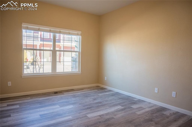 empty room with hardwood / wood-style flooring