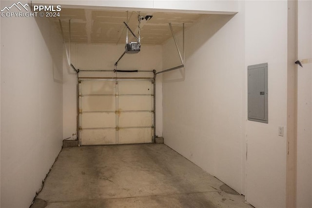 garage featuring electric panel and a garage door opener