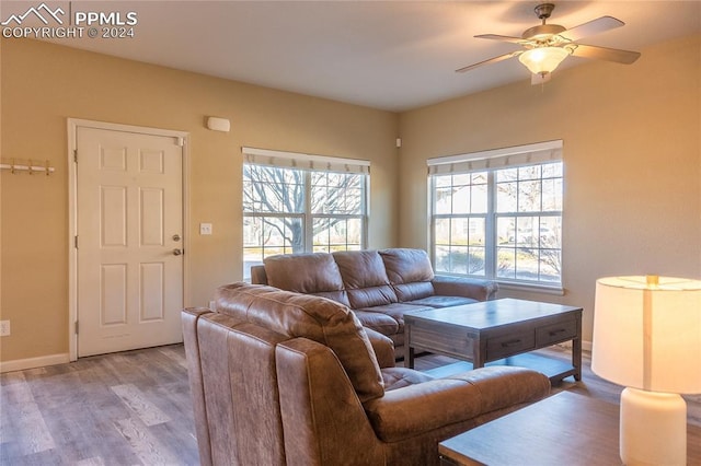 living room with light hardwood / wood-style floors and ceiling fan