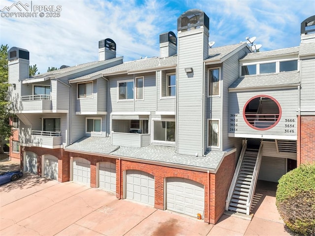 3656 Iguana Dr, Colorado Springs, CO 80910 - view of building exterior featuring concrete driveway, stairway, and a garage