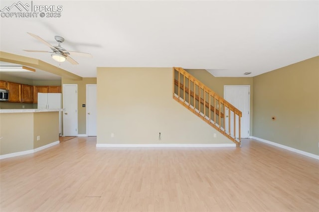 unfurnished living room featuring light hardwood / wood-style flooring and ceiling fan