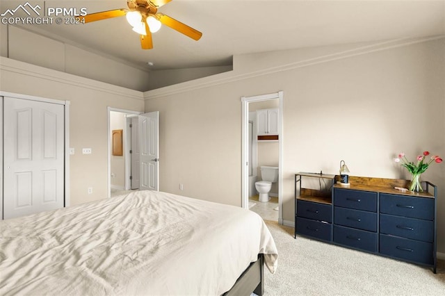 bedroom featuring connected bathroom, ceiling fan, light colored carpet, lofted ceiling, and ornamental molding