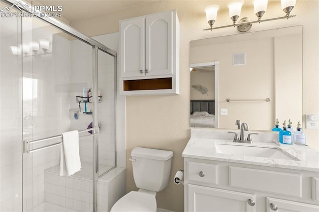 bathroom with toilet, vanity, and walk in shower