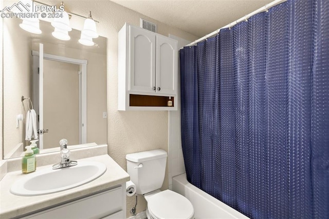 full bathroom with vanity, shower / bath combo, a textured ceiling, and toilet