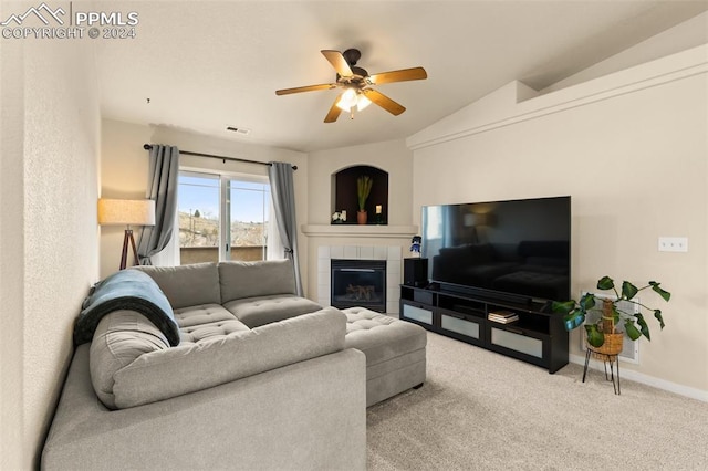 living room featuring a tile fireplace, light carpet, ceiling fan, and lofted ceiling