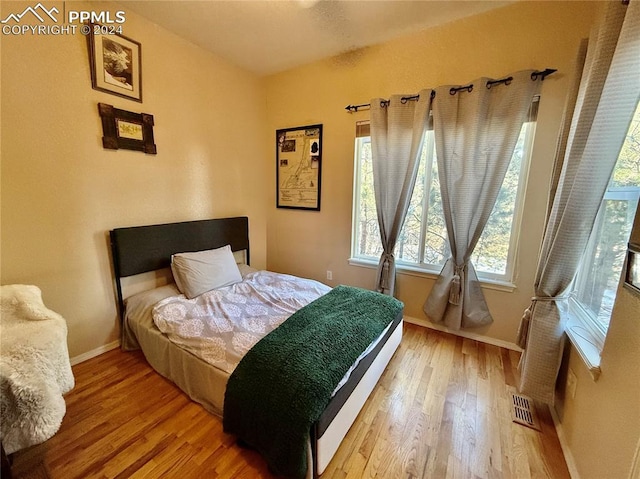 bedroom with wood-type flooring