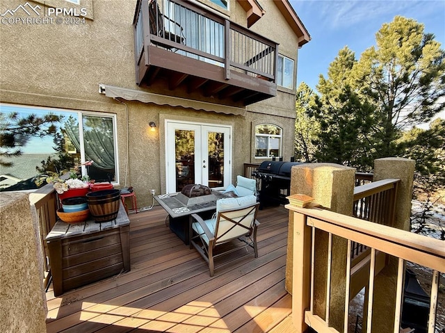 wooden terrace with french doors and a fire pit