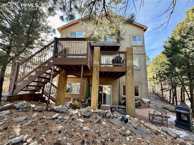 back of property with a patio area and a wooden deck