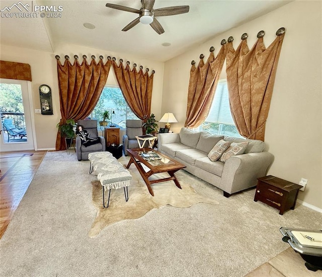 living room featuring ceiling fan and a healthy amount of sunlight