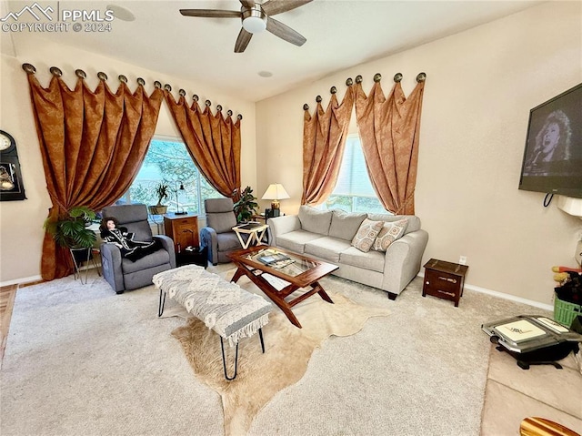 carpeted living room with ceiling fan