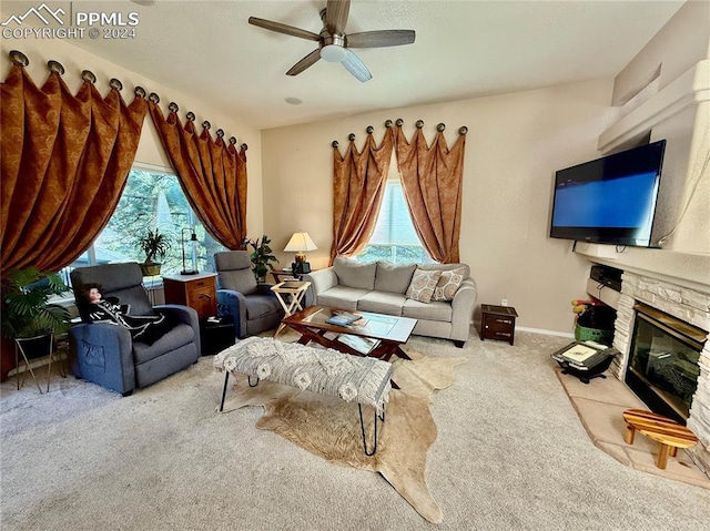 living room with carpet flooring, ceiling fan, and a fireplace