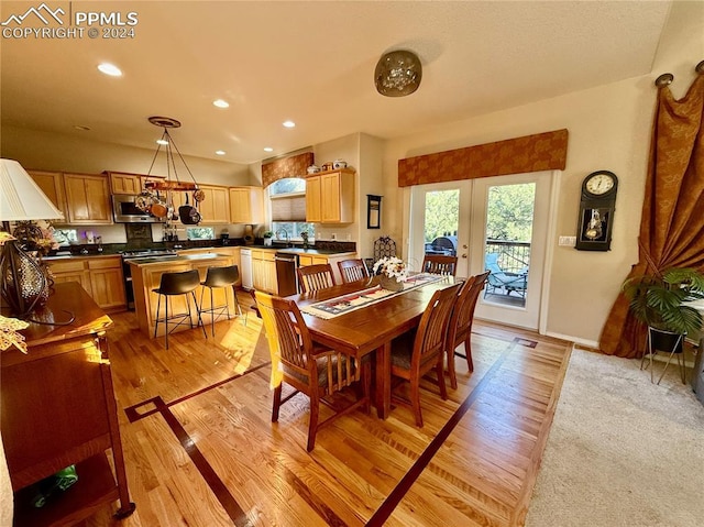 dining area featuring light hardwood / wood-style floors and french doors