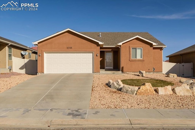 ranch-style home featuring a garage